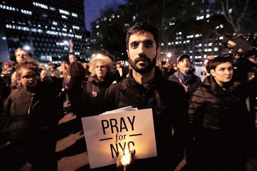 Anoche se realizó una vigilia en Foley Square por las víctimas del ataque con una camioneta perpetrada un día antes en West Side Highway, en Manhattan, Nueva York (JEENAH MOON. REUTERS)