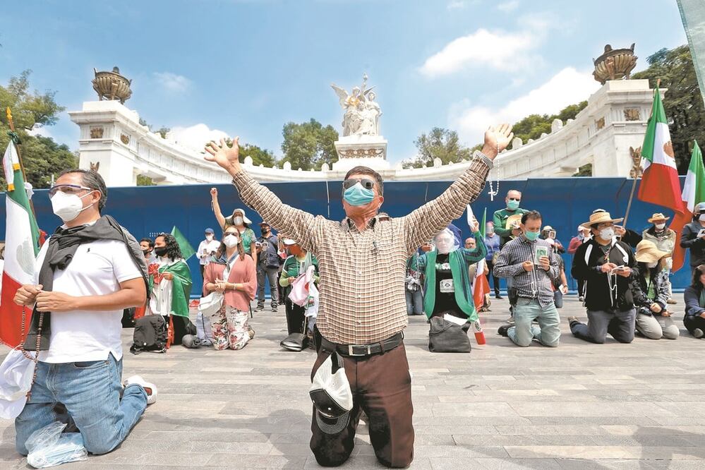 Varios manifestantes, con banderas de México y de la Virgen de Guadalupe, se pusieron a rezar frente al Hemiciclo a Juárez para pedir que su demanda de que Andrés Manuel López Obrador renuncie a la Presidencia se cumpla. Foto: JUAN BOITES. EL UNIVERSAL