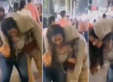 Mujer carga a su novio ebrio en su espalda y lo lleva a casa