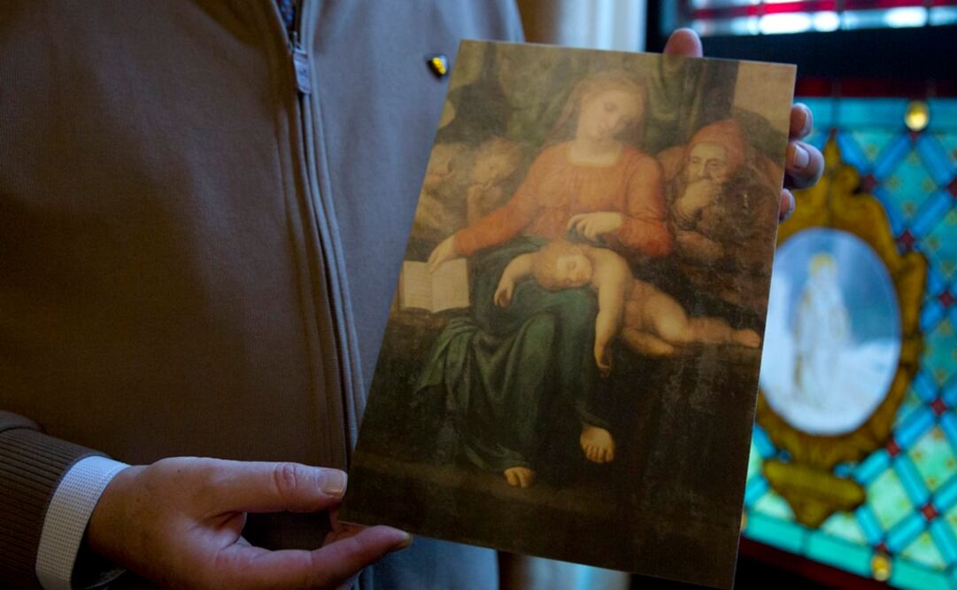 El pastor de Sint-Ludgeruskerk, Jan Van Raemdonck sostiene una copia de la obra "Madonna del Silenzio". Foto: AP/Virginia Mayo