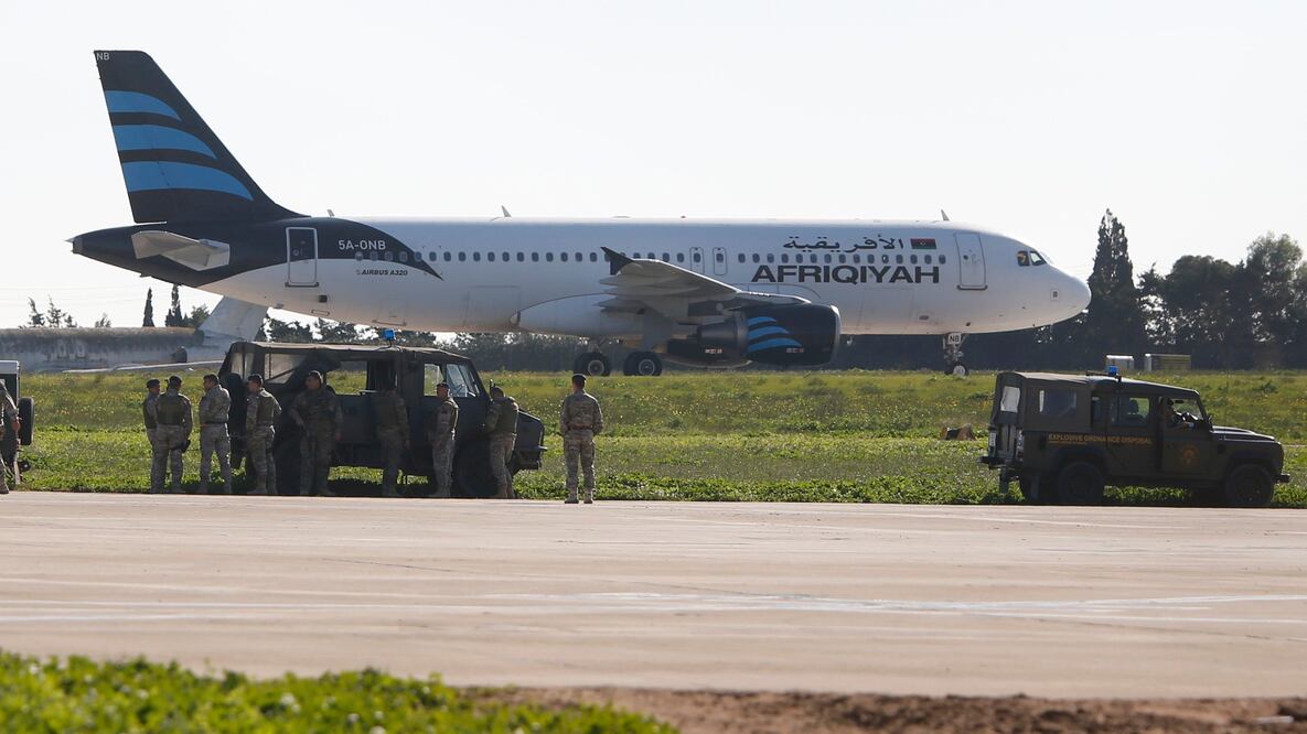 Tropas maltesas examinan el Airbus A320 de la aerolínea Libyan Afriqiyah Airways, en la pista del aeropuerto de Malta. (REUTERS/Darrin Zamit-Lupi)