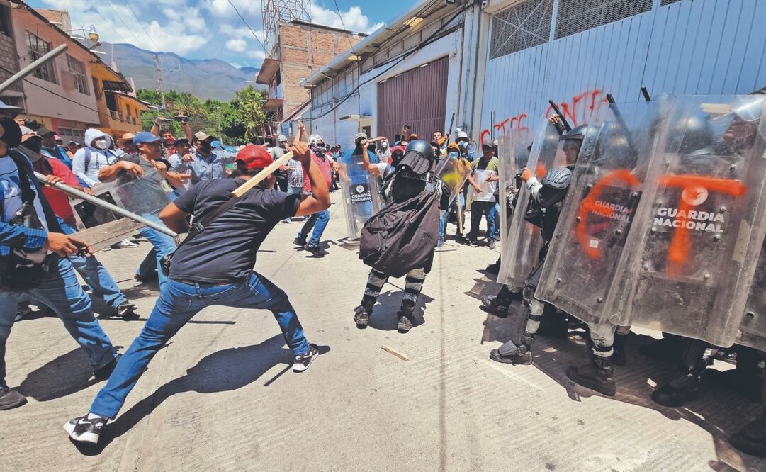 Con palos y tubos, maestros trataron de derribar la contención que montaron soldados con sus escudos frente al INE en Guerrero. Foto: Anwar Delgado/ EL UNIVERSAL
