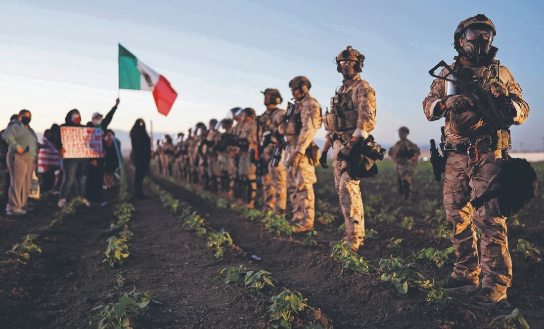 Agentes federales y miembros de la Guardia Nacional bloquean a personas que protestaban contra la redada del ICE en una granja de cannabis. Foto: de MARIO TAMA. AFP