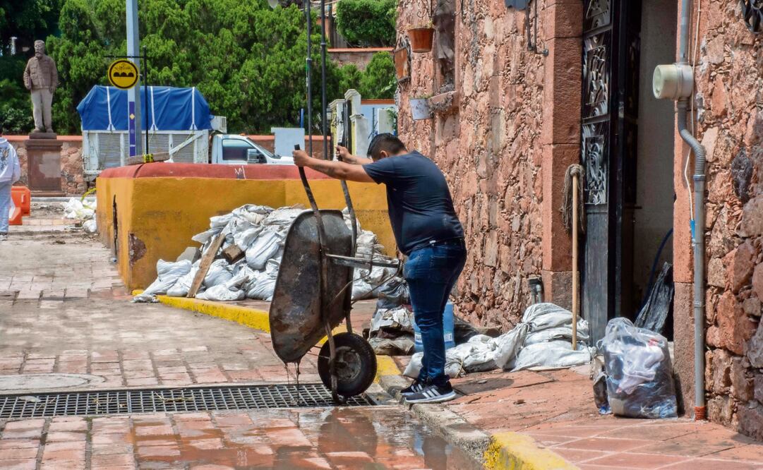 Trabajadores sacaban ayer lodo de algunas casas y negocios. Foto: Mitzi Olvera / EL UNIVERSAL