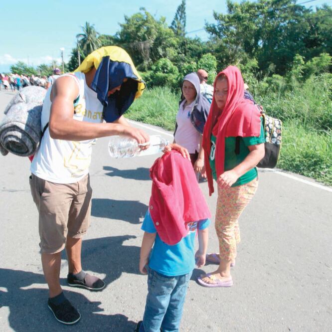 Bajo los intensos rayos del sol, una familia de migrantes caminó 35 kilómetros hasta Tapachula, pese a la amenazas de ser detenidos. FREDY MARTÍN PÉREZ. EL UNIVERSAL