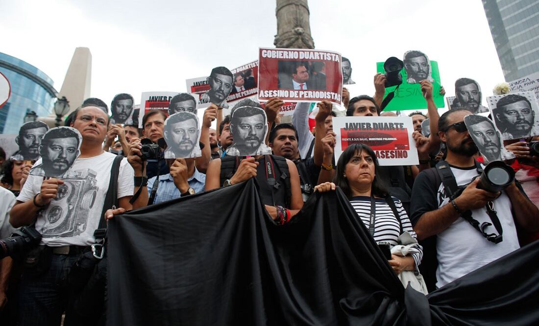 Journalists and activists hold up cut-out images of slain photojournalist Ruben Espinosa during a protest on August 2, 2015 in Mexico City. (Photo: AP)