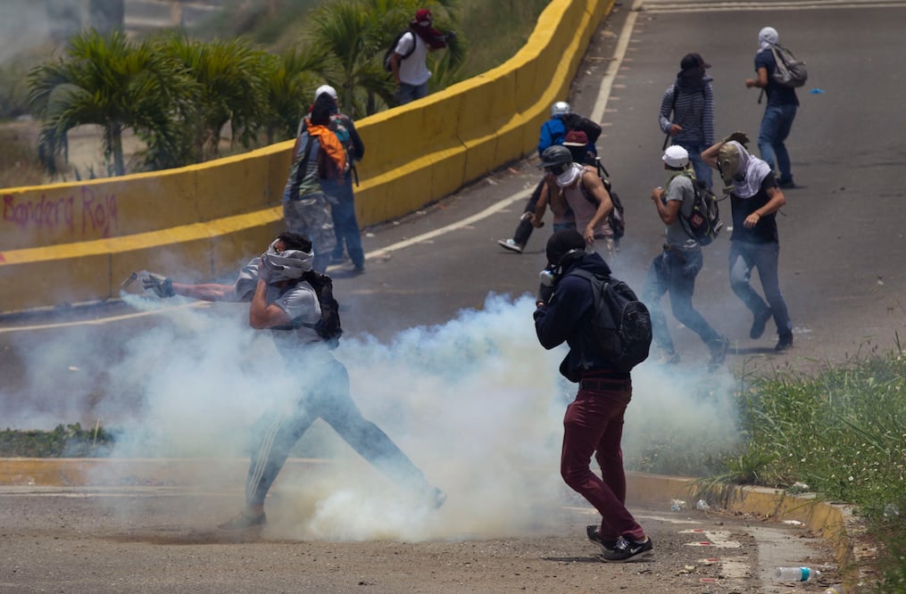 Manifestantes chocan con la Policía Nacional Bolivariana durante una protesta en Caracas. (Foto: AP)
