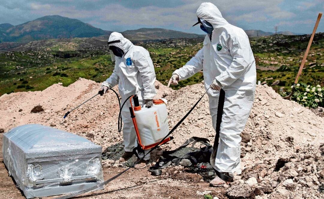 Cemetery workers wearing protective gear prepare to bury an unclaimed COVID-19 coronavirus victim, at the Municipal cemetery No. 13 in Tijuana, Baja California - Photo: Guillermo Arias/AFP