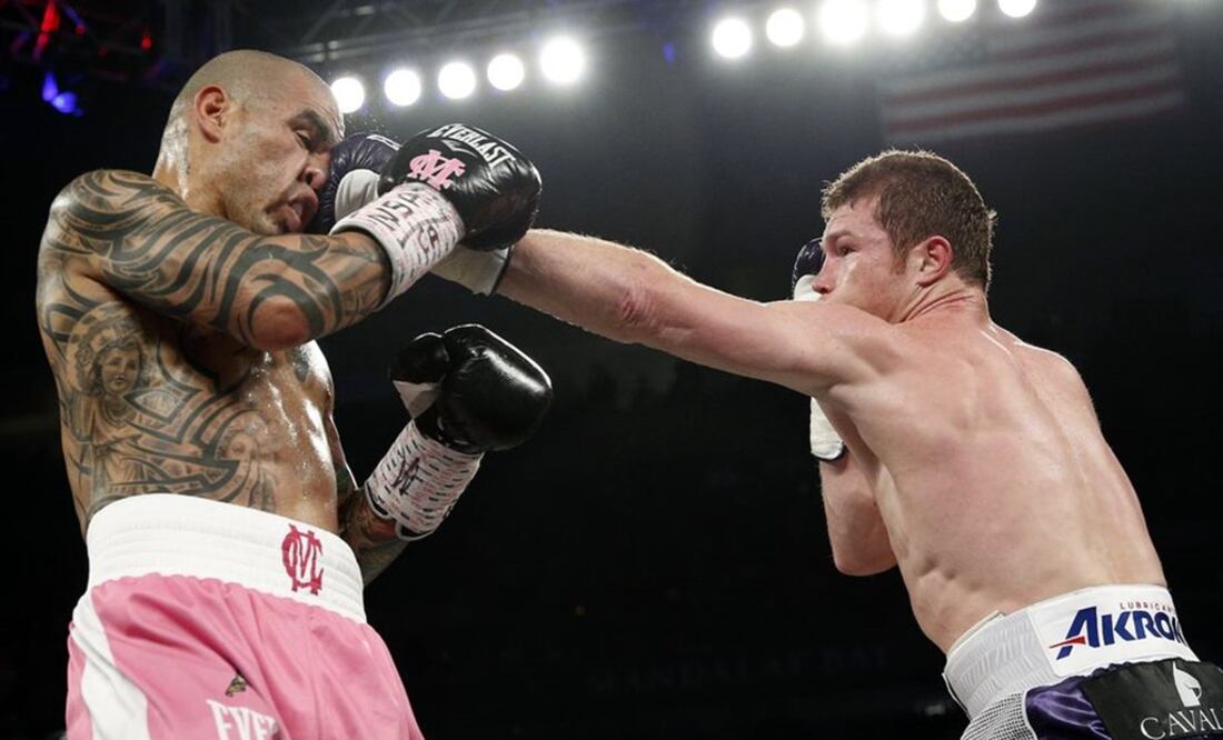 Miguel Cotto gets hit by Canelo Alvarez during their WBC middleweight title bout in Las Vegas.