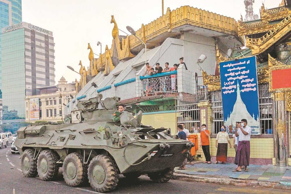 Un tanque circula junto a la Pagoda Sule, tras días de protestas en Rangún. AFP 