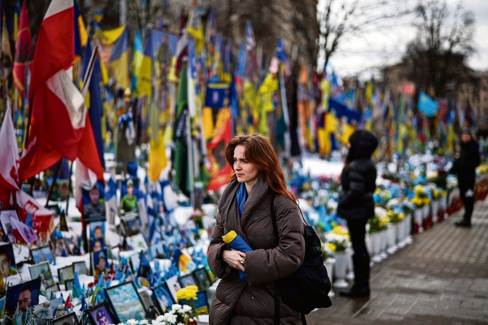 Asistentes a un monumento improvisado para soldados ucranianos y extranjeros en la Plaza de la Independencia de Kiev, en el cuarto aniversario de la invasión rusa a Ucrania. Foto:Henry Nicholls / AFP