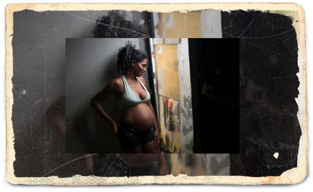 Tainara Lourenco smiles as she chats with neighbors from the entrance of home at a slum in Recife, Brazil. (Photo: AP)