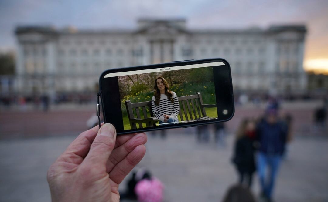 Una persona observa un anuncio en un teléfono inteligente fuera del Palacio de Buckingham de la Princesa de Gales. Foto: AP