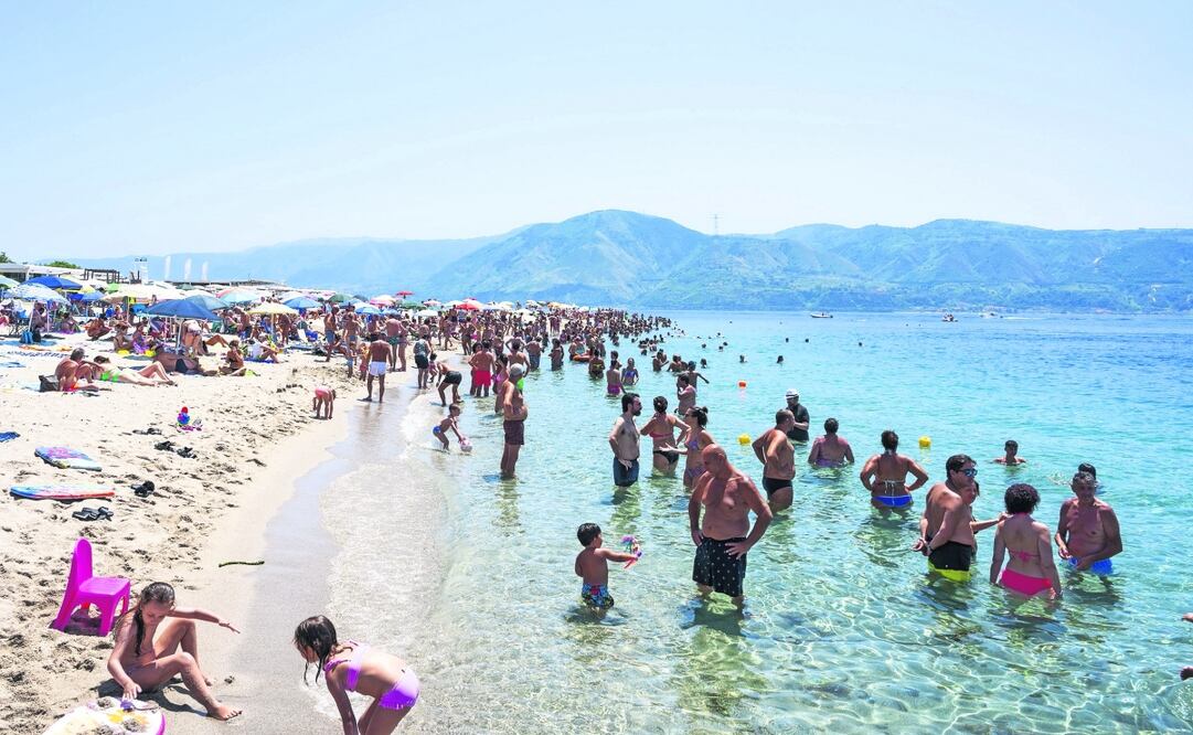 La gente decidió refrescarse en la playa Torre Faro Pilone, en la isla italiana de Sicilia, en medio de la ola de calor. Foto: AFP