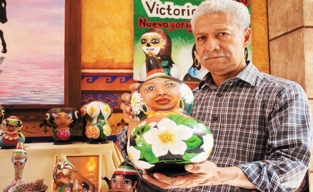 The artist and his dried calabashes as canvas